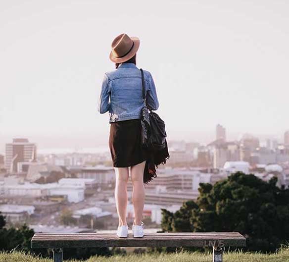 woman standing on bench