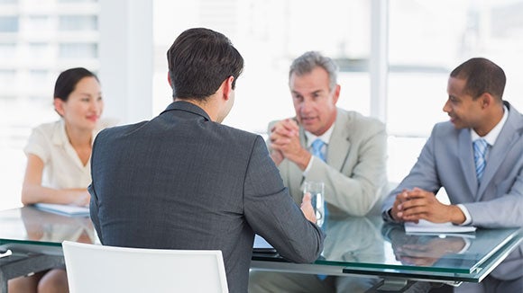 professionals in a senior interview around a table