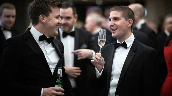 Two men celebrating the MEN Business of the Year Awards