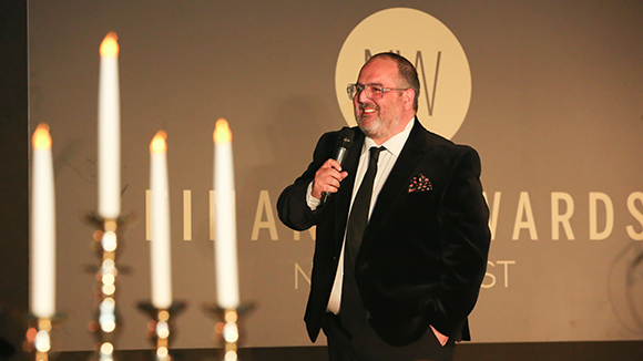 Male accepting an award at the finance awards and giving a speech 