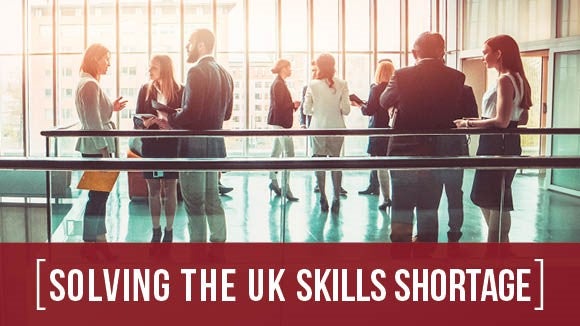 Solving the UK Skills Shortage banner image with green bar and two people discussing research results