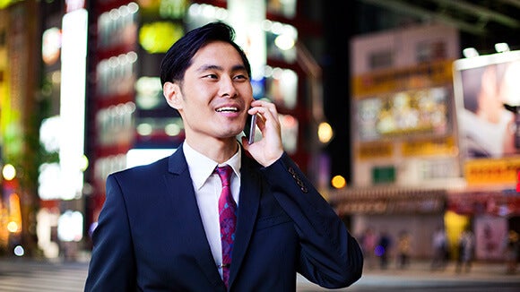 professional in suit talking on phone operations professional in suit discussing pay rise on phone