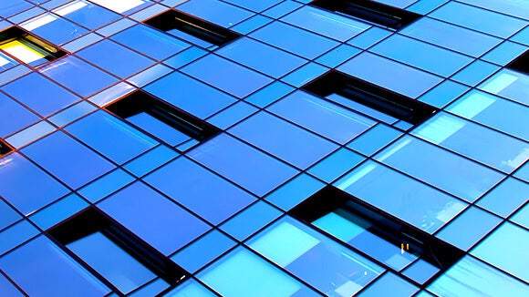 blue glass building panels with offices showing