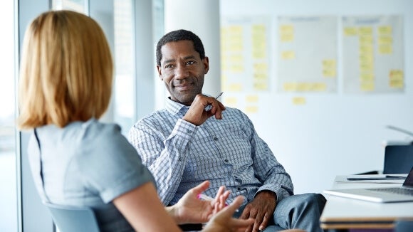 two people discussing the benefits of payroll services two people discussing the benefits of payroll services