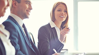 Woman suit locum legal professional Locum legal professional asks question during a meeting