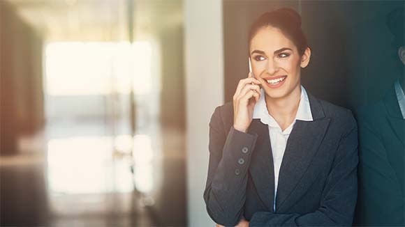 woman on mobile phone woman stepping outside of meeting to take phone call