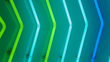 Blue and green neon bars pointing right