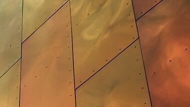 metallic bronze metal building panels behind craft a killer brand statement text