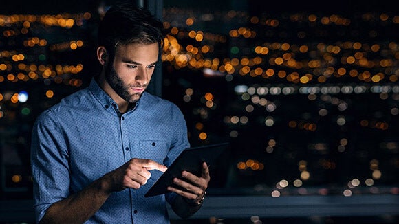 man on tablet downloading salary survey man on tablet downloading the robert walters salary survey