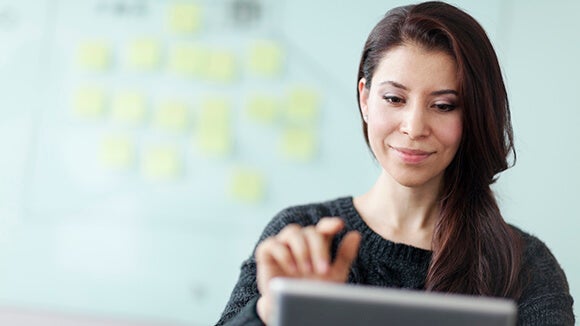 woman on tablet downloading salary survey woman on tablet downloading salary survey