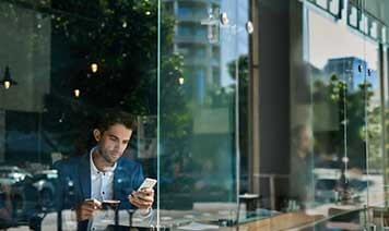 man on phone in cafe outside reflection