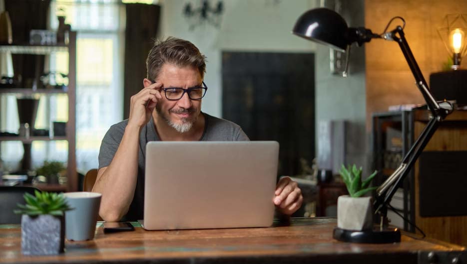Man working with laptop at home office