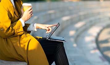 Woman with coffee on tablet