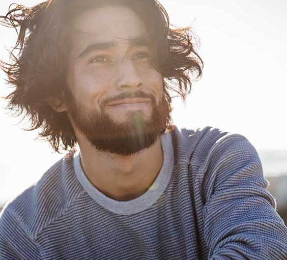 man smiling by the ocean