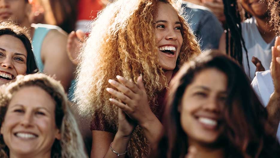 happy woman cheering at sports game