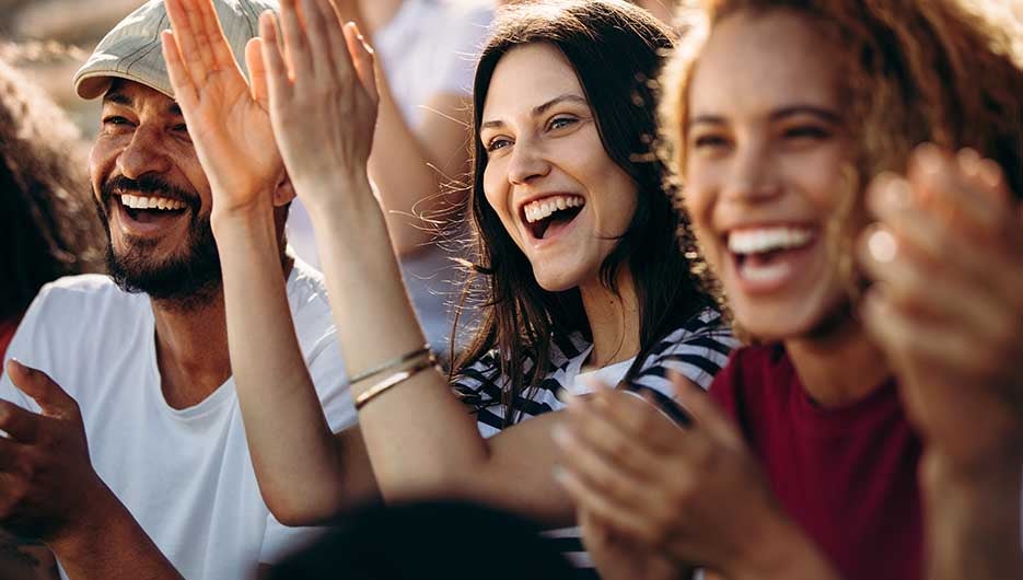 happy woman cheering at sports game