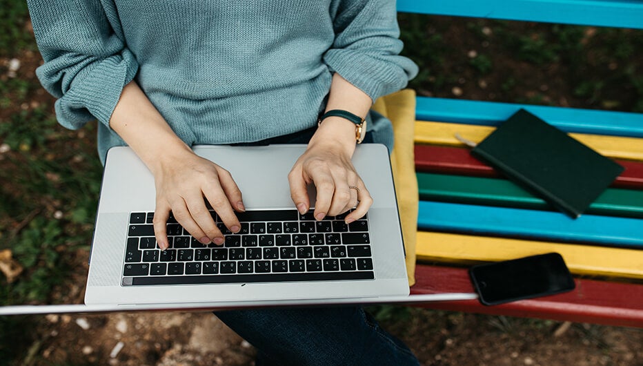 sitting on bench with laptop