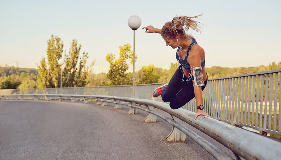 woman jumping over railing