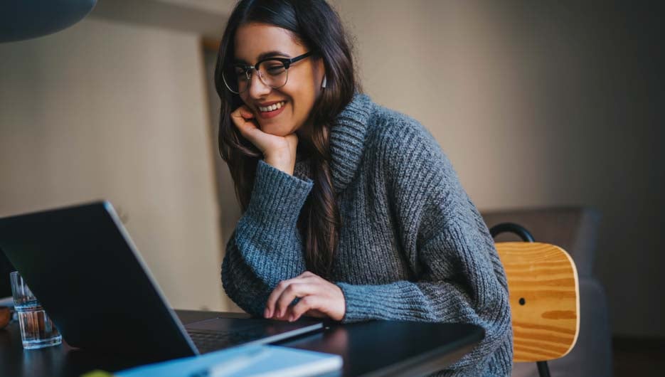 Happy smiling young woman using laptop computer device while working remotely at home office, Cheerful businesswoman in casual clothes having video meeting via laptop, Video Chat Communication Concept
