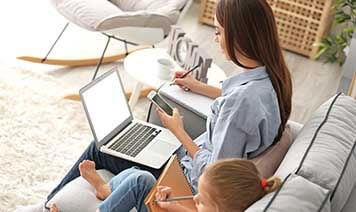 Woman on sofa with laptop